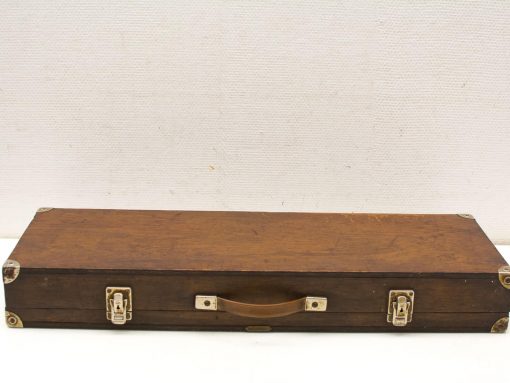 Vintage wooden case with metal corners and handle, perfect for storage and stylish decor.