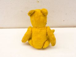 Vintage yellow teddy bear exuding warmth, nostalgia, and childhood comfort. Perfect for collectors.