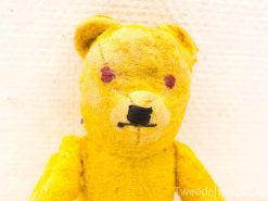 Charming vintage yellow teddy bear, exuding nostalgia and warmth, ideal for cuddles and adventures.
