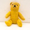 Charming vintage yellow teddy bear exuding warmth and nostalgia; perfect for collectors and decor.