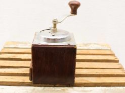 Vintage wooden coffee grinder with a shiny steel lid, perfect for coffee lovers.