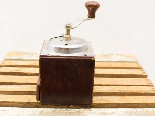 Vintage wooden coffee grinder with a shiny steel lid, perfect for coffee lovers.