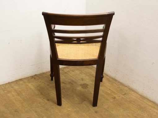 Elegant wooden chair with woven cane seat, showcasing craftsmanship and timeless style.