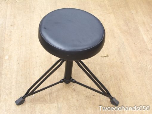 Stylish black minimalist stool with cream cushioned seat, perfect for any decor.