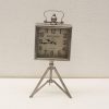 Antique 1870 metal clock with cream face and tripod stand, perfect vintage decor piece.