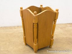 Rustic wooden wastebasket with ventilation, elegant design, and sturdy legs for any room.