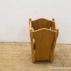 Charming wooden magazine holder with curved edges and sturdy legs for stylish organization.