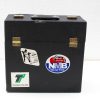 Vintage black suitcase with travel stickers and elegant brass locks, perfect for adventure seekers.