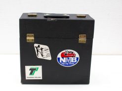 Vintage black suitcase with travel stickers and elegant brass locks, perfect for adventure seekers.