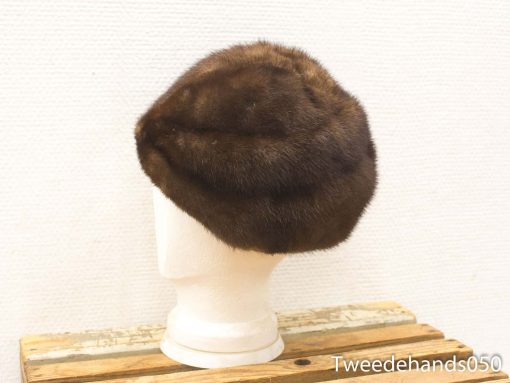 Elegant vintage fur hat in deep brown, featuring luxurious finish and classic cloche design.