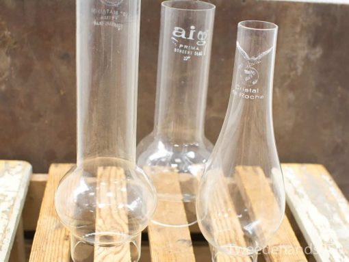 Set of three vintage glass laboratory flasks for decorative or practical use.
