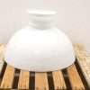 Elegant white porcelain vase with gold accent on rustic wooden pallet. Perfect for home decor.
