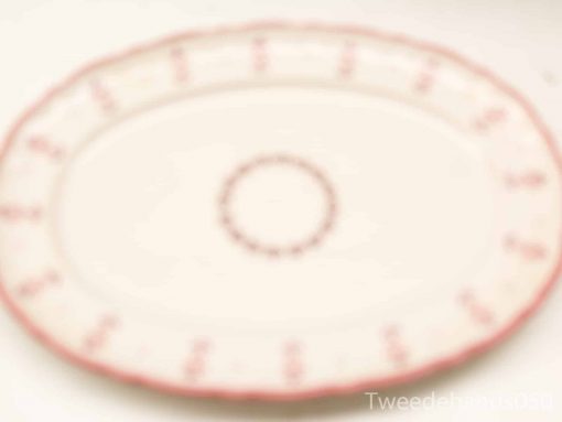 Elegant oval serving platter with soft pink border, perfect for special gatherings and timeless memories.