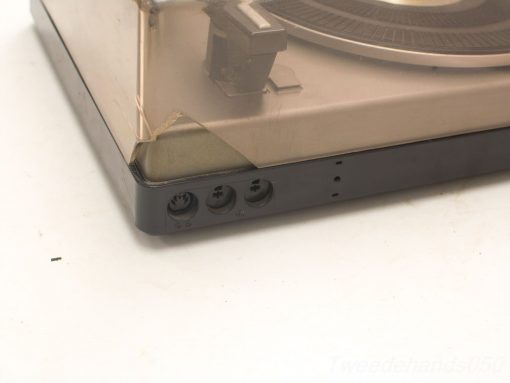 Classic vintage turntable with dust cover and precise tonearm for audio enthusiasts.