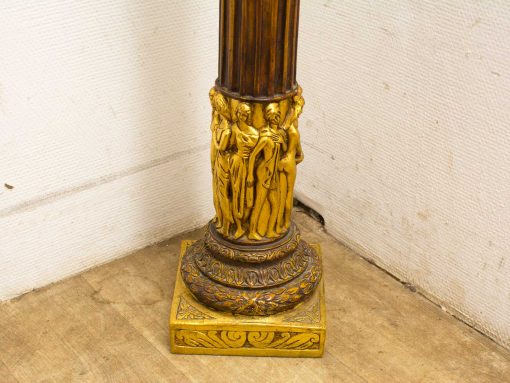 Ornate column with gold details and intricate carvings, ideal for elegant interior decor.