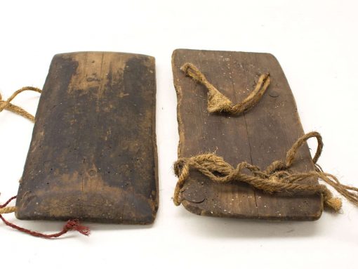 Vintage wooden boards with ropes, showcasing unique wear and stories from their past.