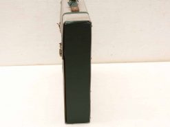 Vintage green suitcase, durable and charming, perfect for travel or decor enthusiasts.