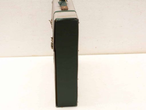 Vintage green suitcase, durable and charming, perfect for travel or decor enthusiasts.