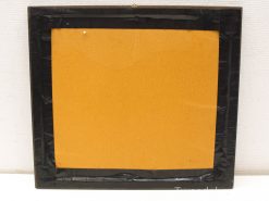 Minimalist black frame with vibrant mustard yellow backing, ideal for showcasing art or photos.