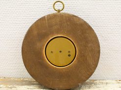 Antique brass wall decor with recessed center, featuring three circular holes for unique charm.