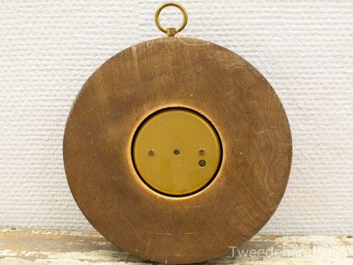 Antique brass wall decor with recessed center, featuring three circular holes for unique charm.