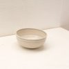 Elegant creamy beige ceramic bowl with subtle blue lines for modern or rustic settings.