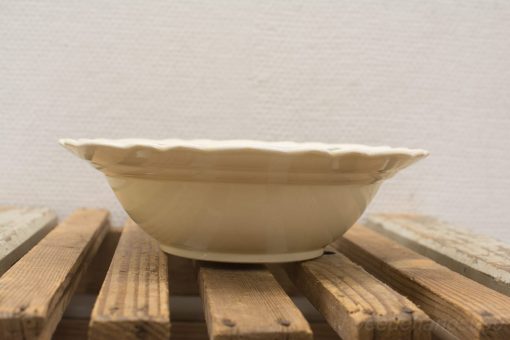 Elegant beige ceramic bowl with scalloped edge, perfect for serving salads or desserts.