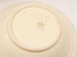 Elegant ivory ceramic dish with handcrafted details and a glossy finish, ideal for collectors.