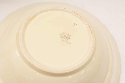 Elegant ivory ceramic dish with handcrafted details and a glossy finish, ideal for collectors.