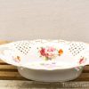 Elegant porcelain dish with floral patterns and gold accents, perfect for dining or decoration.