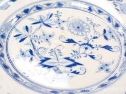 Intricate blue-and-white porcelain dish with floral design, perfect decorative piece for any collection.