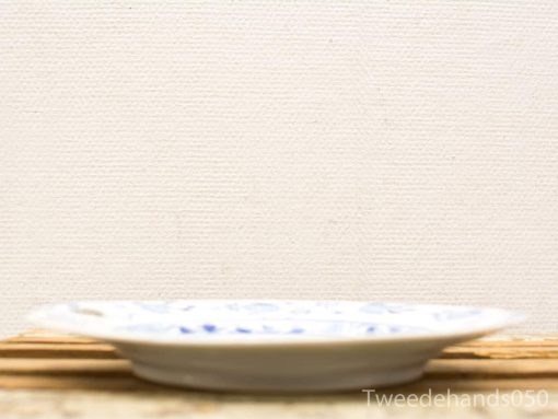 Elegant ceramic plate with intricate blue patterns, perfect for serving food and enhancing decor.