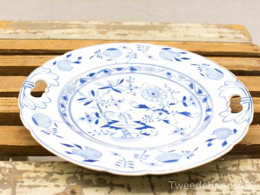 Elegant blue and white porcelain plate featuring a floral design and ornate handles.