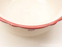 Elegant vintage ceramic bowl with scalloped edge and delicate floral design. Perfect for decor or serving.