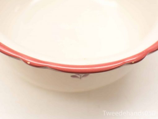 Elegant vintage ceramic bowl with scalloped edge and delicate floral design. Perfect for decor or serving.