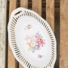 Elegant oval porcelain platter with floral design, perfect for serving and decor.