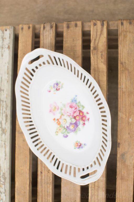 Elegant oval porcelain platter with floral design, perfect for serving and decor.
