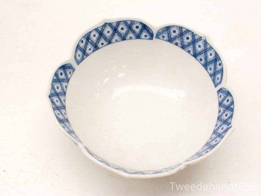 Elegant vintage white ceramic bowl with blue floral design, perfect for decor and serving.