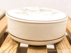 Elegant cream ceramic container with hand-painted floral design for decoration or storage.