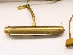 Elegant vintage brass gooseneck lamp for stylish wall decor and versatile lighting.