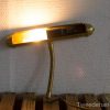 Stylish brass wall lamp with flexible arm for cozy, adjustable lighting in any space.
