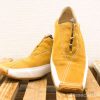 Chic golden yellow suede shoes with zipper and rubber sole for stylish comfort.