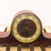 Vintage mahogany clock with elegant design, golden accents, and traditional numerals for timeless charm.
