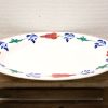 Vintage oval serving platter with vibrant floral design, ideal for any dining occasion.