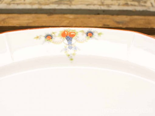 Elegant porcelain serving platter with vibrant orange flowers and decorative rim, perfect for any occasion.