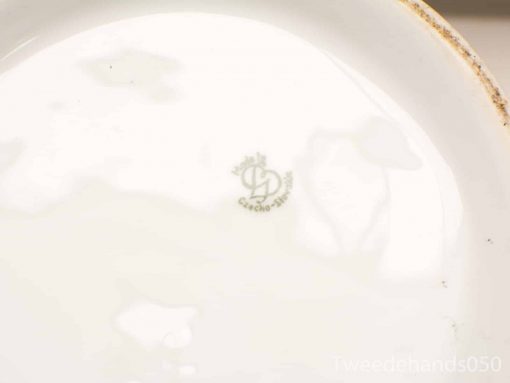 Vintage Czechoslovakian ceramic plate with unique logo and charming wear. Perfect for collectors.