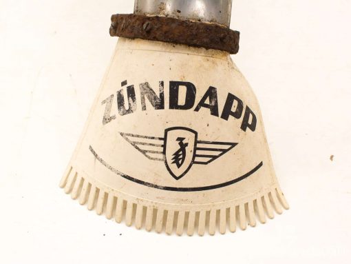 Vintage Zündapp motorcycle mudguard with iconic logo, showing character through wear and aging.