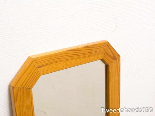Rustic wooden mirror with a warm finish, perfect for enhancing cozy interiors.