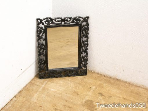Elegant black mirror with ornate frame, perfect for adding vintage charm to any space.