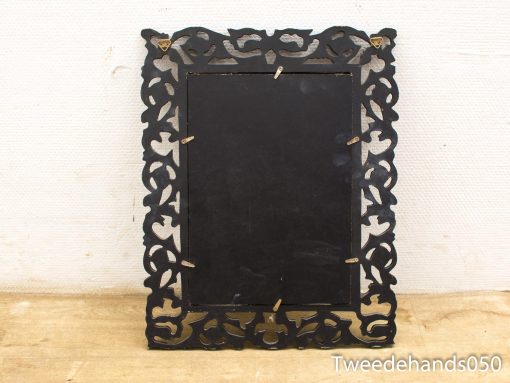 Elegant black wooden picture frame with ornate detailing, perfect for showcasing photos or art.
